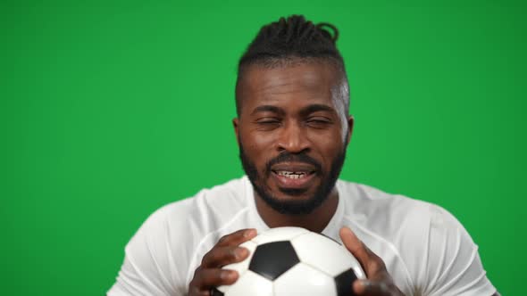 Motivated Confident African American Sportsman Squeezing Football Ball Looking at Camera