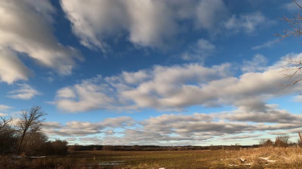 Time lapse of clouds over empty fields.