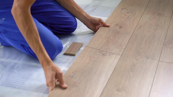 A Man Professional Laminate Installer Laying Laminate Wood