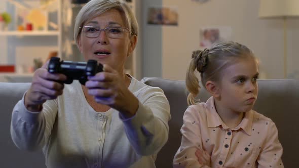 Grandmother Ignoring Child While Playing Video Game With Console, Addiction