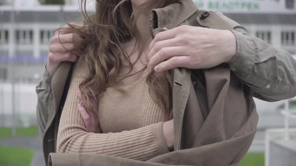 Unrecognizable Young Man Covering Brunette Woman with Coat. Boyfriend Taking Care of Girlfriend