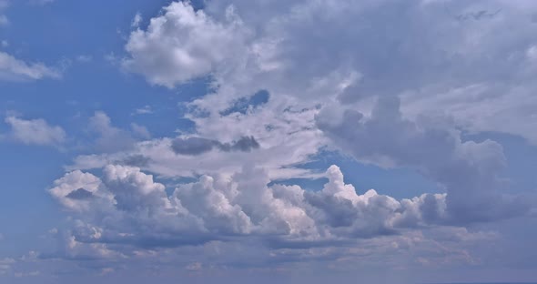 Stunning Panoramic View of Amazing White Clouds Cumulus Floating in the Bright Sunlight on the Sky