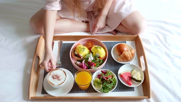 Woman Hand Take a Cup of Coffee Breakfast in Bed Served in Hotel Room