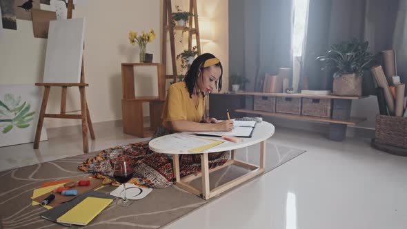 Woman Drawing Picture at Home