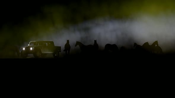 Horse Herd and Off-Road Vehicle Against Foggy Background