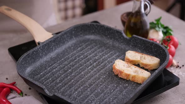 Toasting Slices of Baguette in a Grill Frying Pan