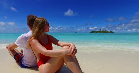 Happy people on honeymoon vacation live the dream on beach on white sand 4K background