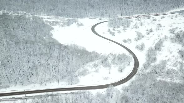 Drones Eye View  Winding Road From the High Mountain Pass in Winter