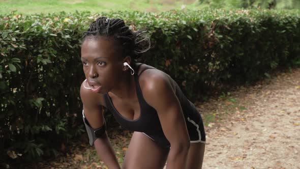 Pretty Black american  Female Jogger Taking Break- slow motion