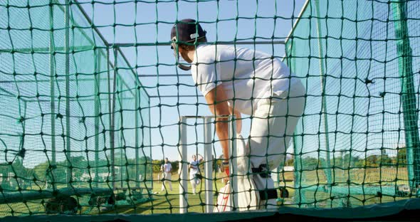 Cricket players practicing in the nets during a practice session