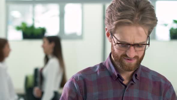 Bearded Manager Turns Papers Nervously, Man Is Angry Because of Work Close Up