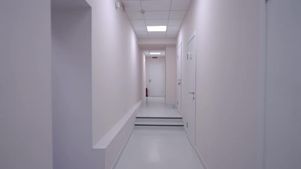 Live Camera Moves Along White Hospital Hallway Indoors