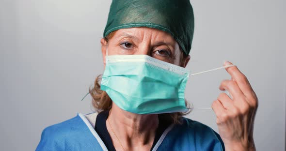 Female Doctor is Taking off her Mask.