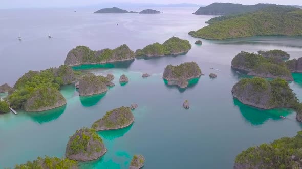 drone footage flying over a blue tropical lagoon in Indonesia