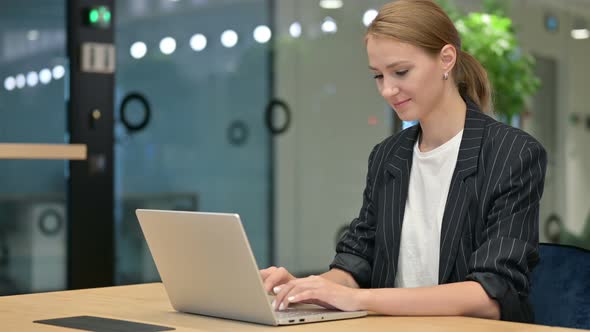 Positive Businessman with Laptop Doing Thumbs Up