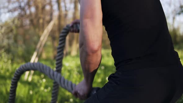 Aiming Footage of a Male Arms Waving Battle Ropes