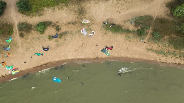 AERIAL: Top View of the Beach Filled With Pro Athletes Preparing to Kite