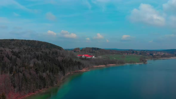 Slow aerial pan, showing Gmund and the surroundings of the lake Tegernsee in Bavaria during springti