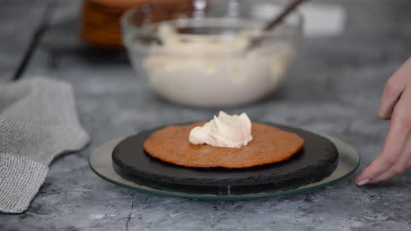 Young Caucasian Woman Making a Layer Cake with Whipping Cream