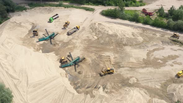 Aerial view of mining machinery working at sand quarry. Mining equipment