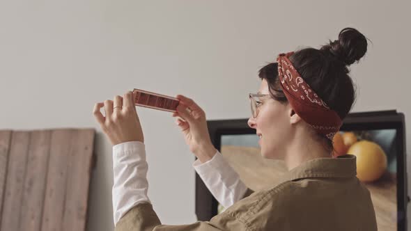 Female Photographer Checking Filmstrip