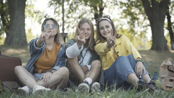 Group Positive Hippies Showing Peace Gesture Smiling