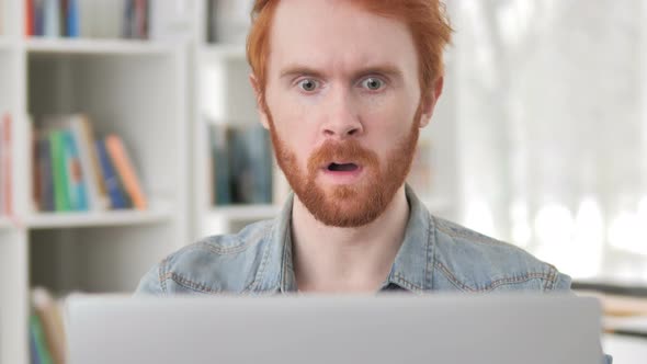 Shocked Casual Redhead Man Working on Laptop