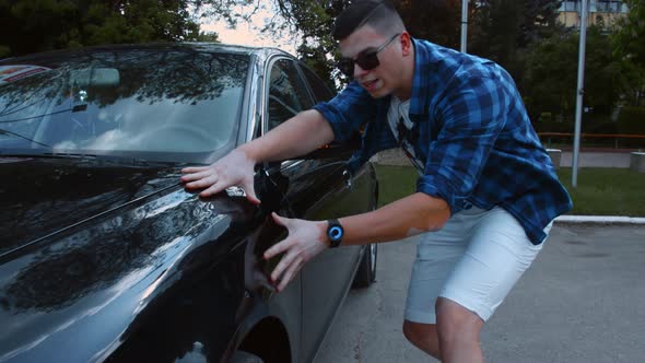 Male Car Expert with Vitiligo Making Review of a Car for Audience Interested in Automobiles