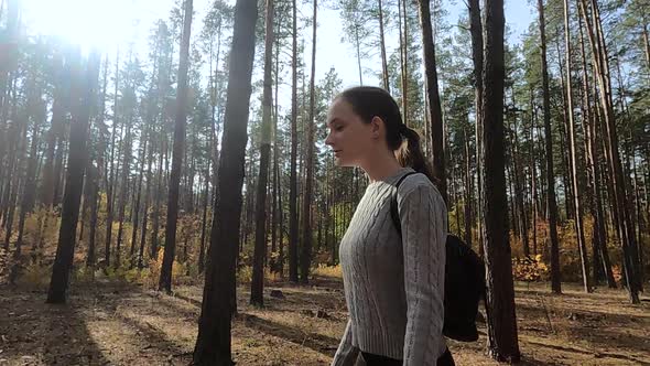 The Girl Walks Through the Autumn Forest