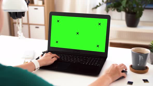 Woman with with Green Screen on Laptop at Home