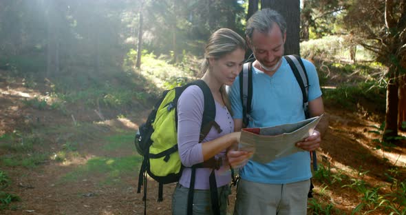 Hiker couple interacting while looking at map