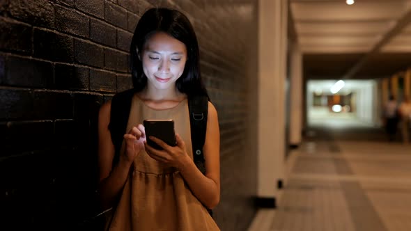 Woman use of mobile phone in city 