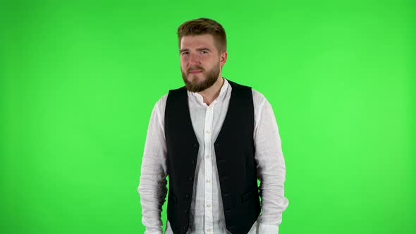 Man Laughs While Looking at Camera. Green Screen