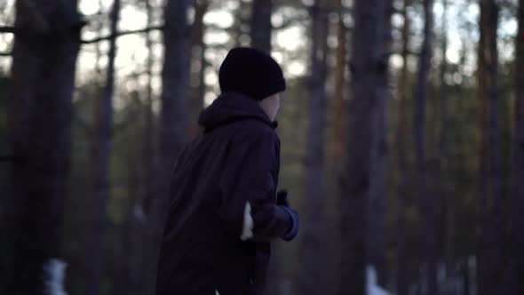 Young Male Athlete Jogging In Wintry Wood