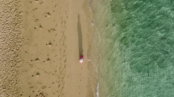 Overhead Shot of Women Silhouette Shadow Walking By Sandy Beach with Ocean Waves