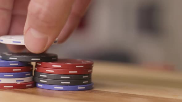 pan left of poker chips being stacked close up