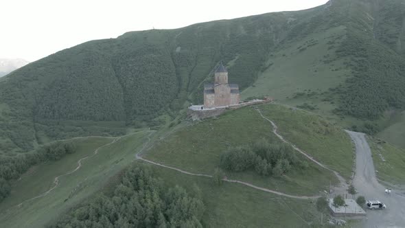 Stepantsminda, Georgia - May 8 2021: Aerial view of Gergeti Trinity Church, Tsminda Sameba. Kazbegi