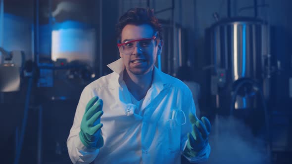 Portrait of Crazy Scientist Laughing at Camera in Large Smoky Laboratory