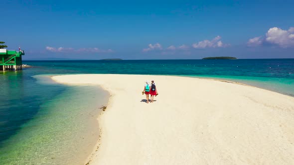 Girls Tourists Strolling on a Tropical Beach. Perfect White Sand Beach, View From Above.
