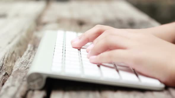 Close Up Child Hand Typing Keyboard