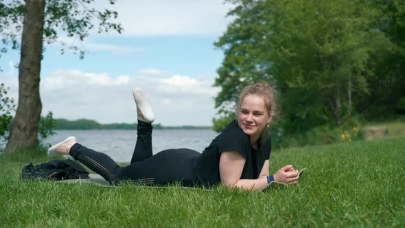 Young Girl Exercising By the Lake