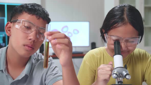 Boy And Girl Learning Science Experiment In Laboratory At Classroom. Study With Scientific Equipment alt