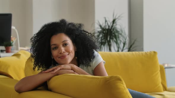 Portrait of a Young African American Woman Looking at the Camera and Smiling Cute