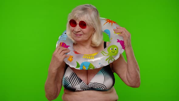 Elderly Woman Tourist in Swimsuit Dancing Celebrating Smiling with Rubber Ring on Chroma Key