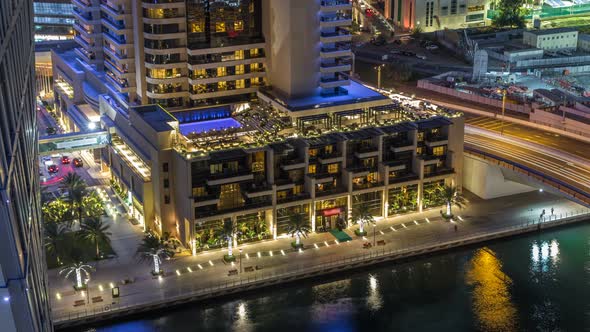 Luxury Dubai Marina Canal with Passing Boats and Promenade Night Timelapse Dubai United Arab