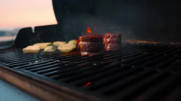 BBQ close-up: filet mignon steak and grilled vegetables cooking with fire. Cooking barbeque