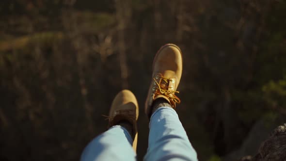 Close Up Hiking Boots of Independent Woman Traveller on Top of Mountain Looking at View