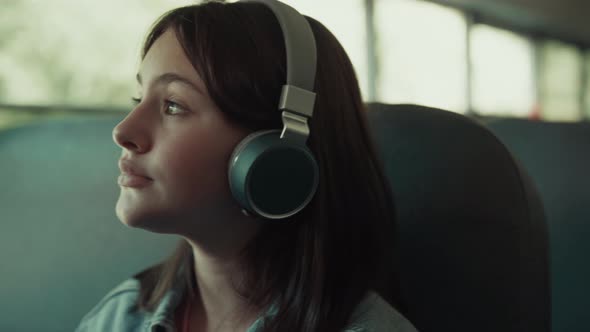 Girl Teenager Traveling Bus with Headphones Close Up