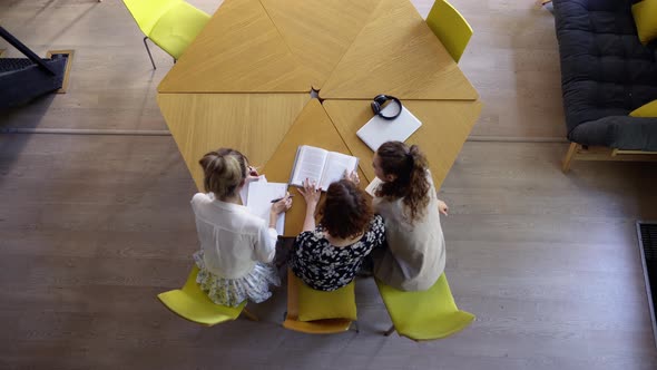 Female Students Studying Together in Library Top View