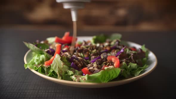 Pouring the Sauce on Freshly Prepared Salad